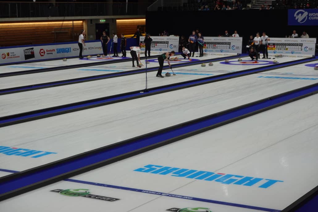 Panoramic view of the floodlit curling rinks for the 2026 World Mixed Doubles and Senior Championships.